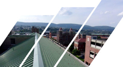 Green commercial roof with shingles and metal